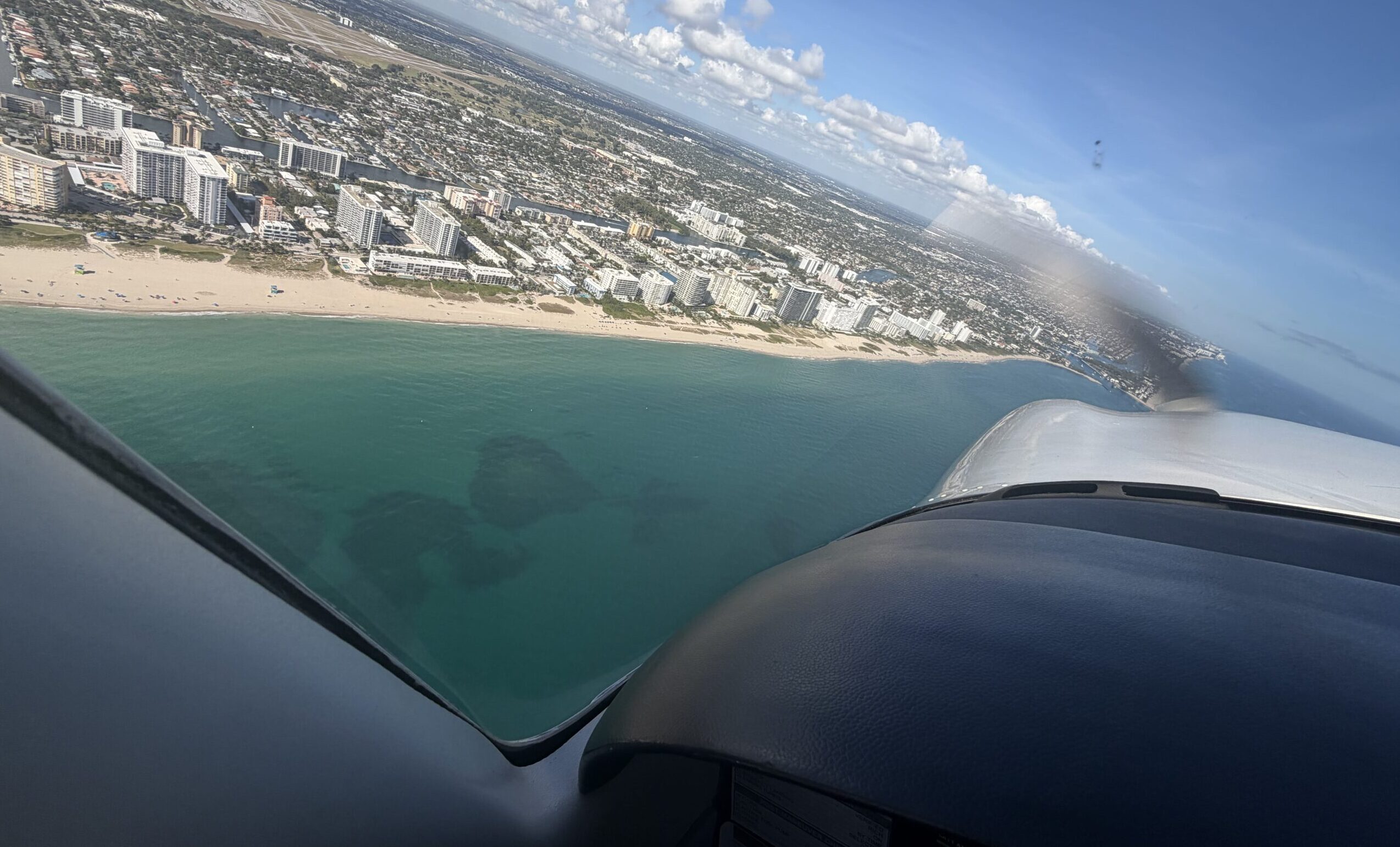 flying a plane over a beach